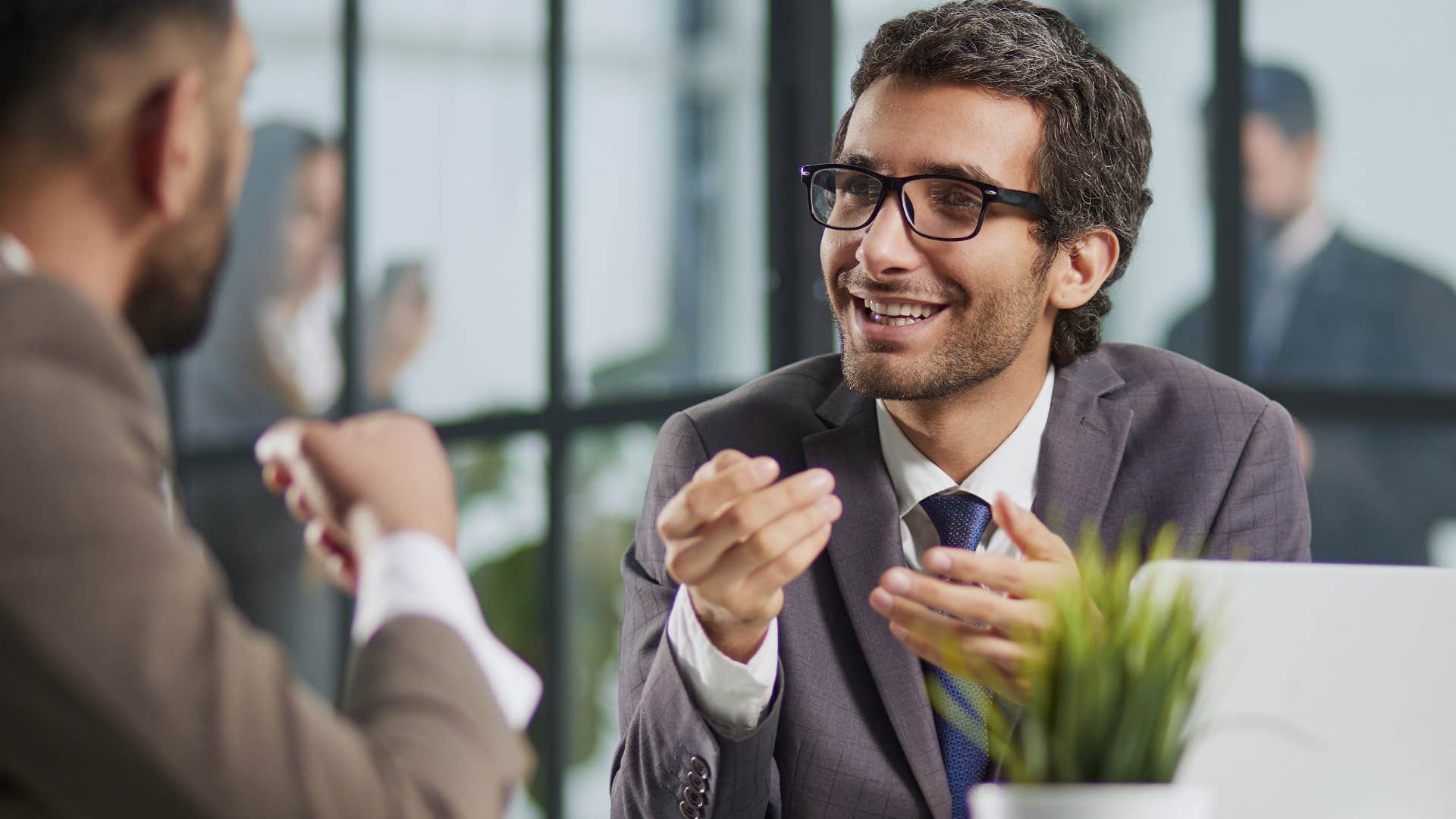 professional man talking to a peer at work