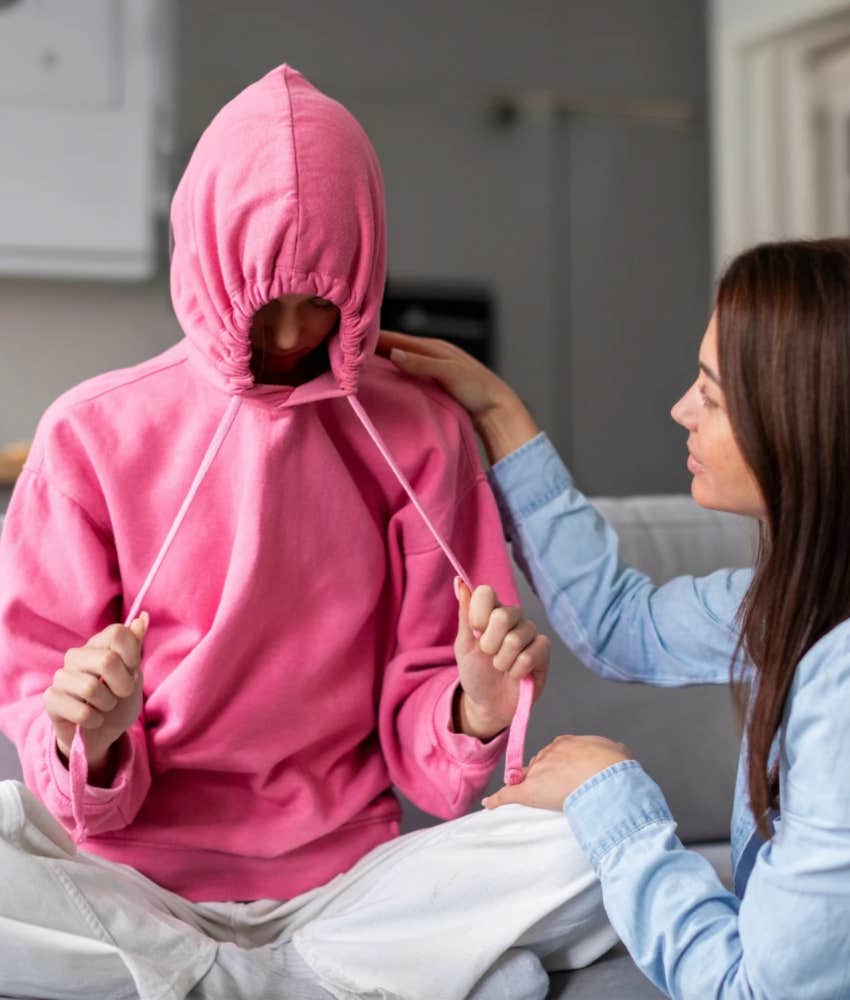 Teen hiding in pink hoodie, mom trying tools for talking to teens