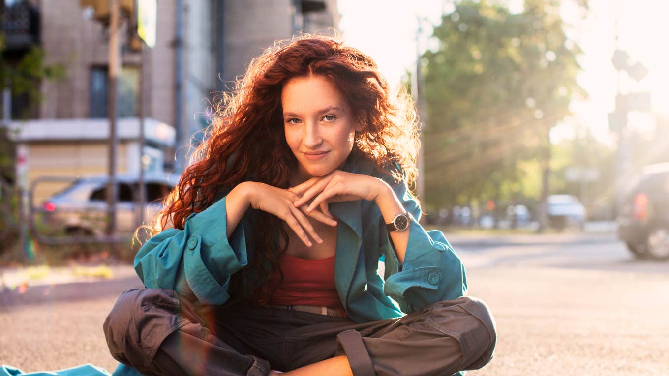 Redheaded teen girl only listening vaguely to her parents talking