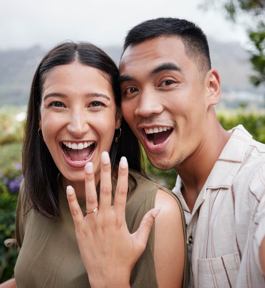 Happy couple show off ring