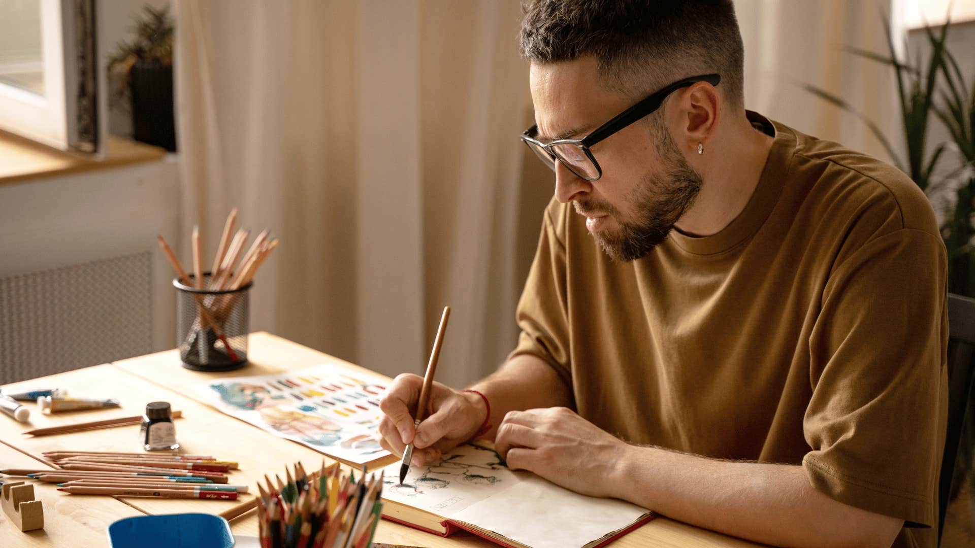 man drawing in notebook