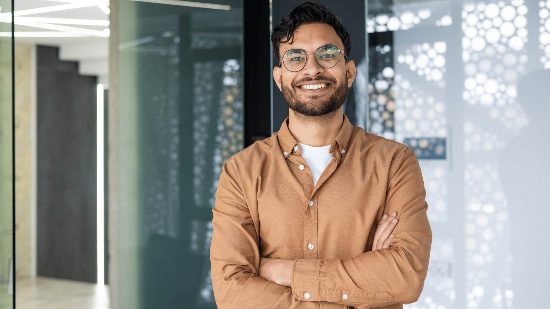 man smiling with his arms crossed