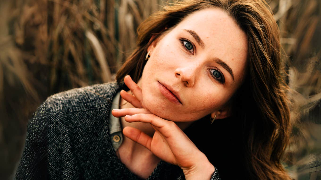 Woman pondering wondering what she needs to be happier.