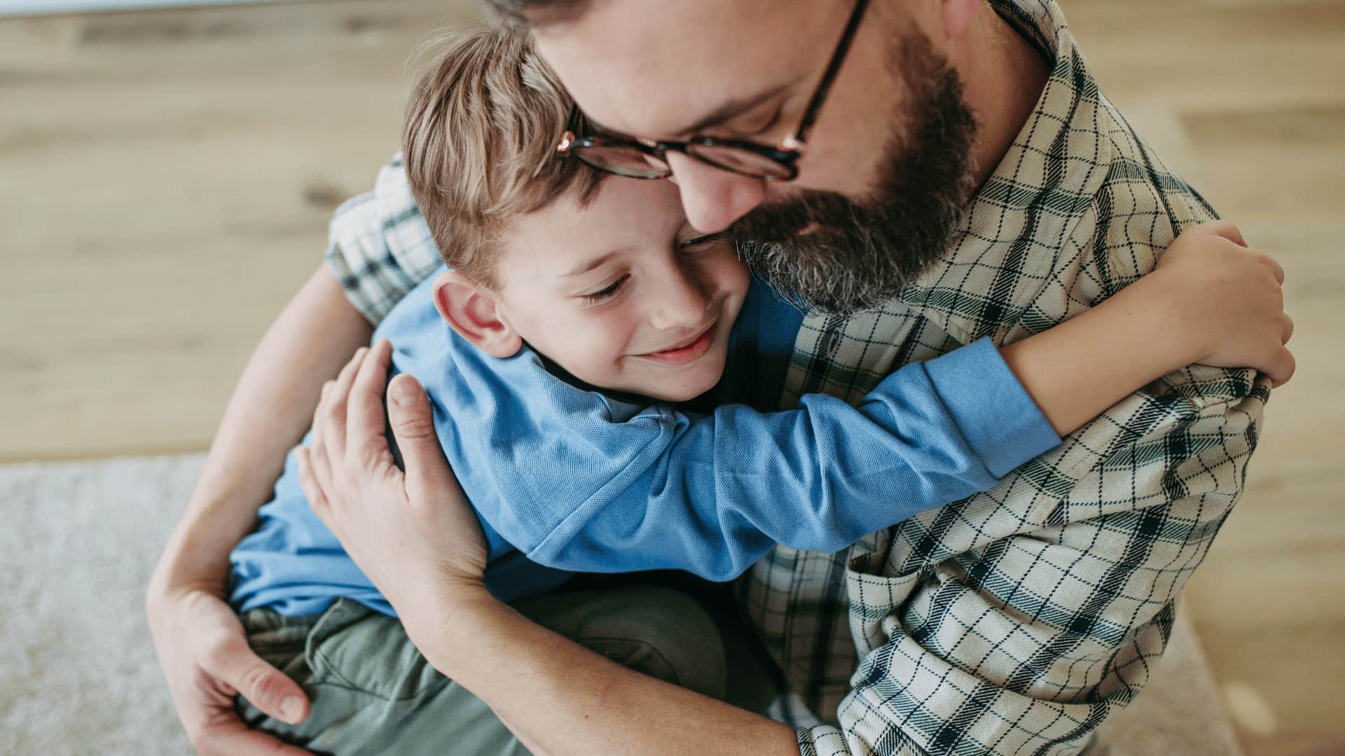 man hugging his son