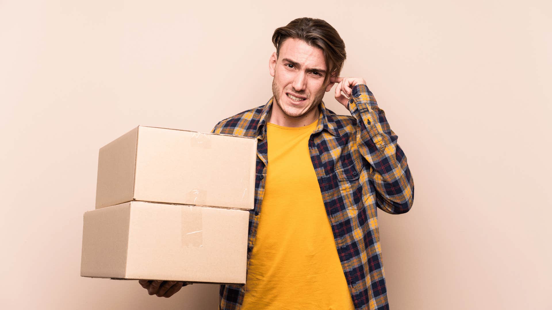 upset man holding boxes