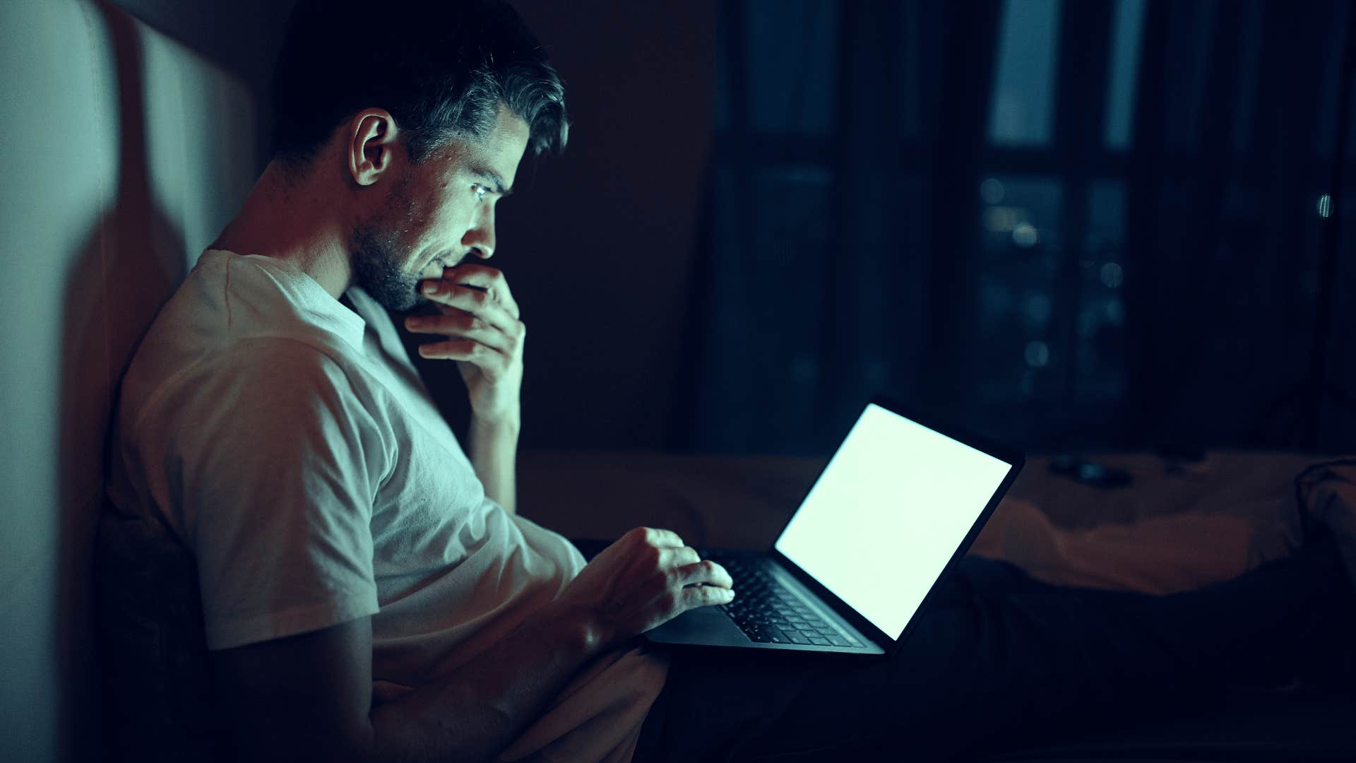 man on laptop in dark