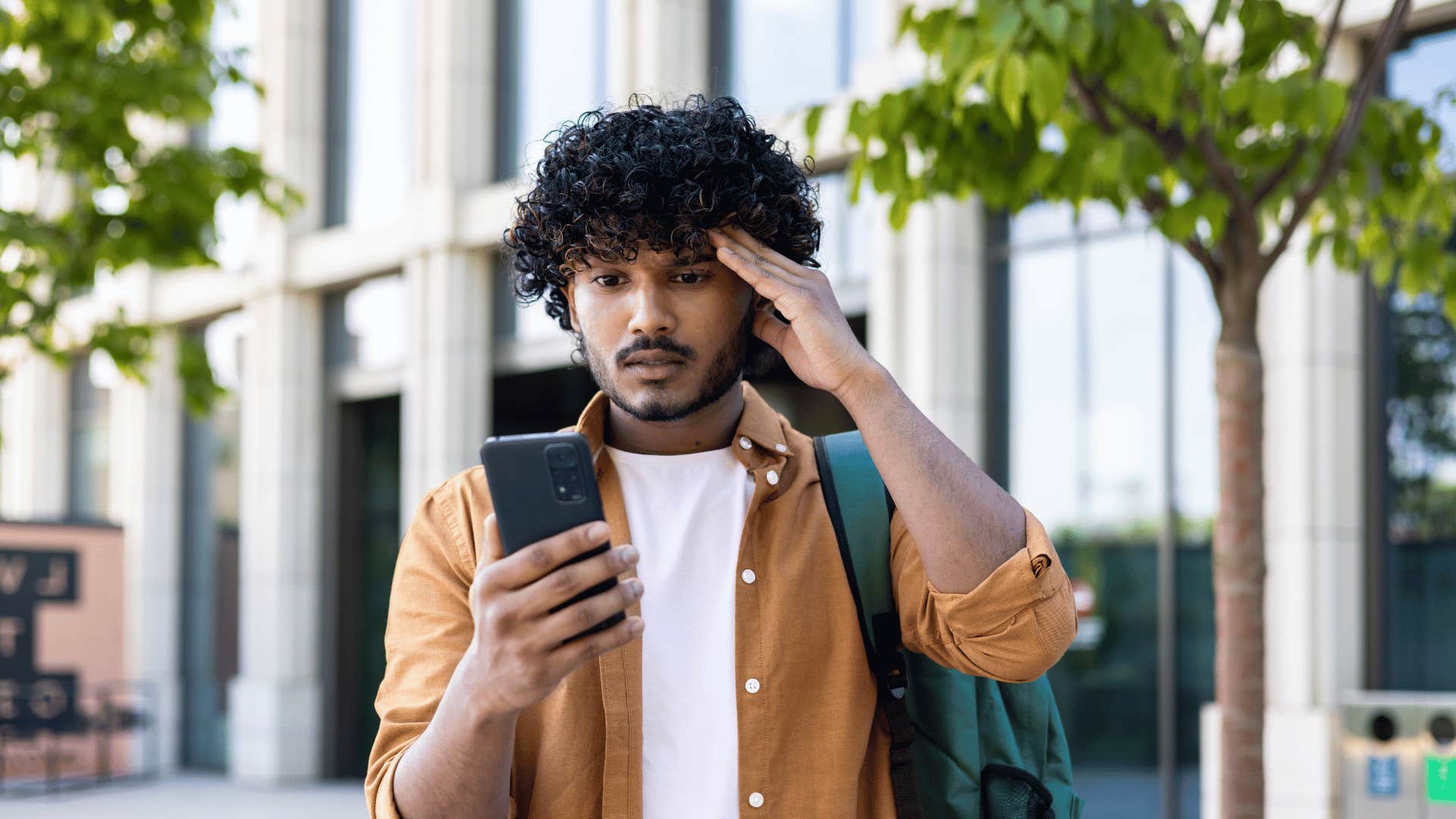 upset man looking at phone