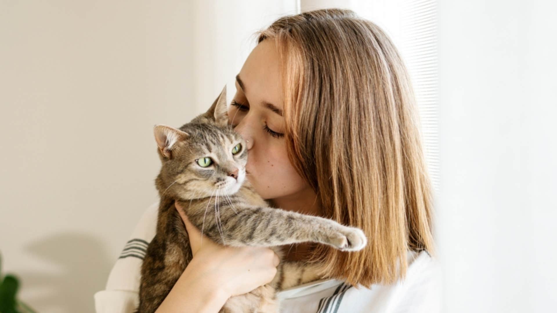 woman giving cat affection