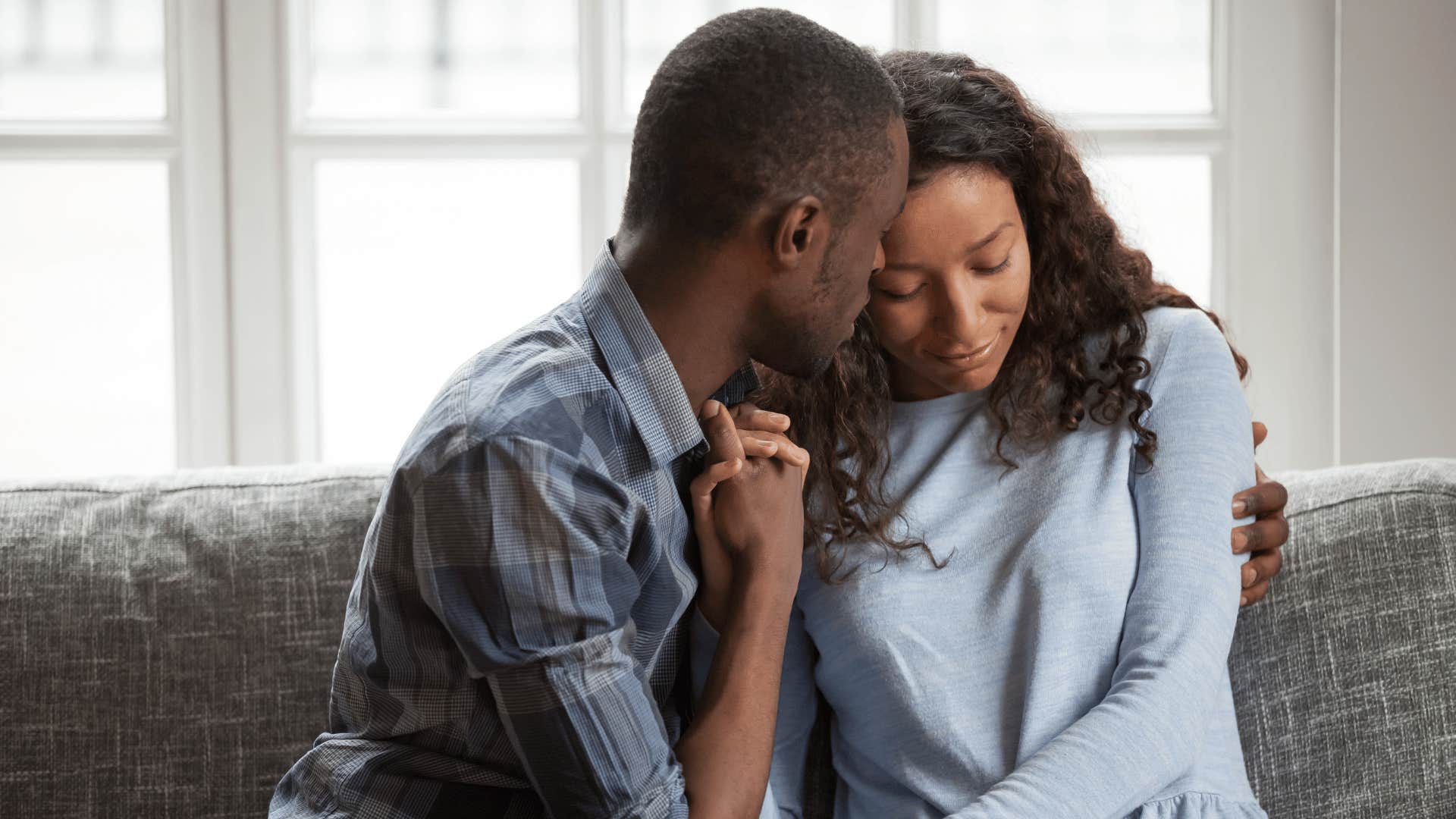 man comforting upset woman