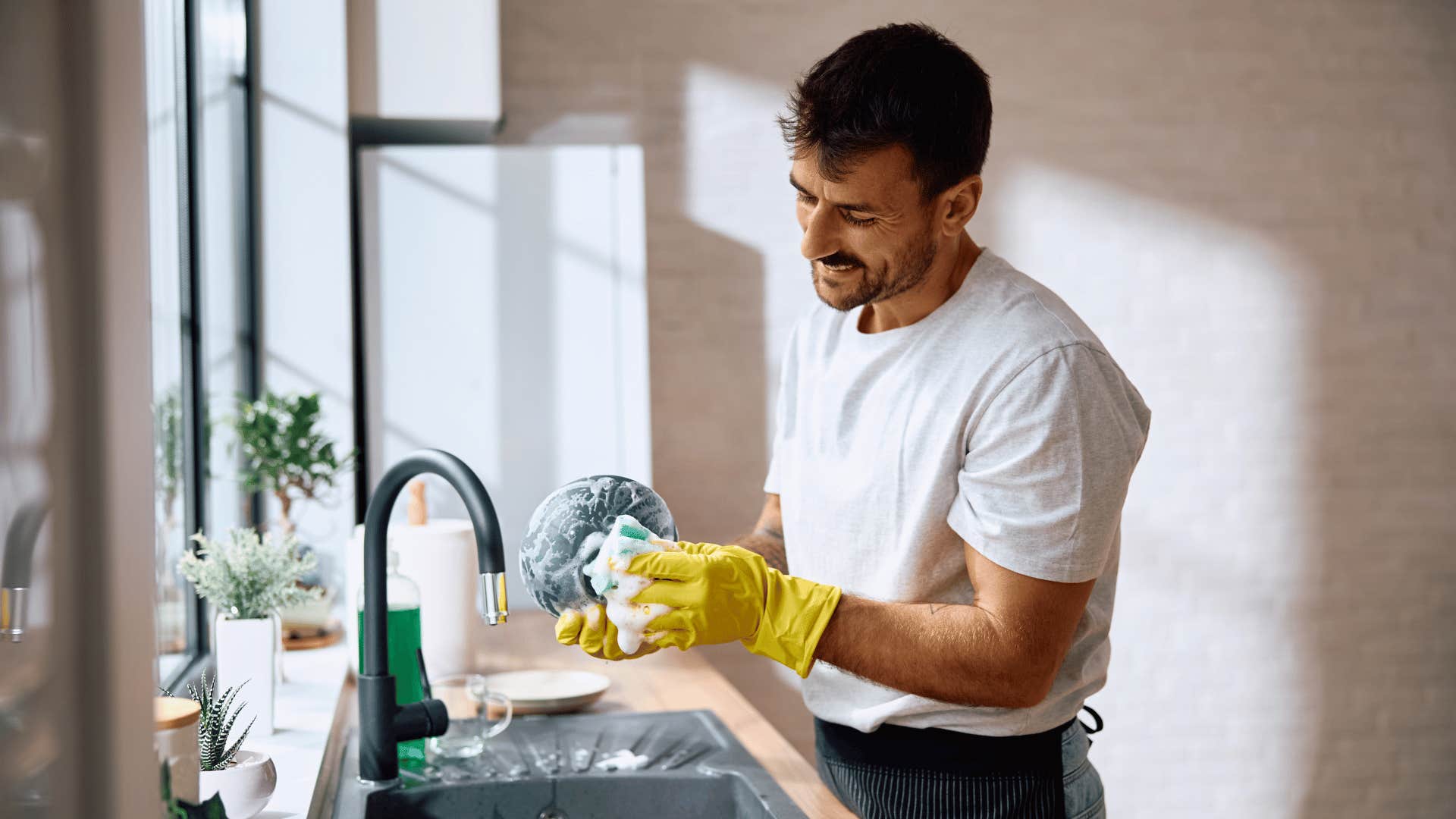 man washing dishes