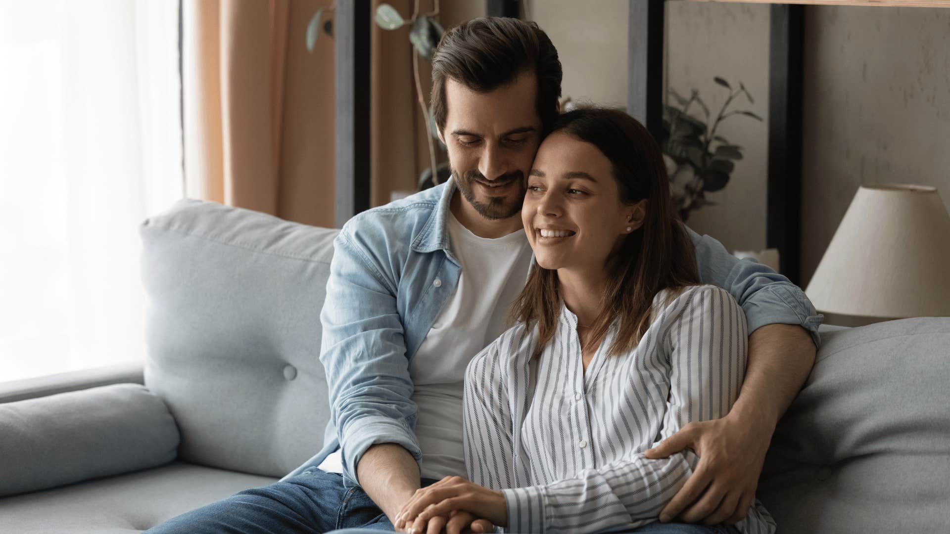 respectful man holding woman cuddling