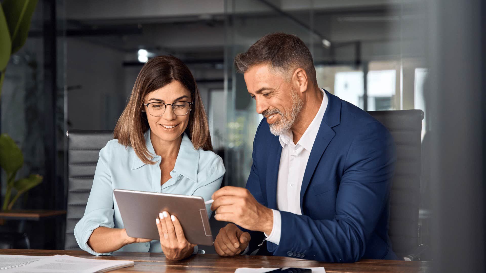 woman and man talking in front of tablet