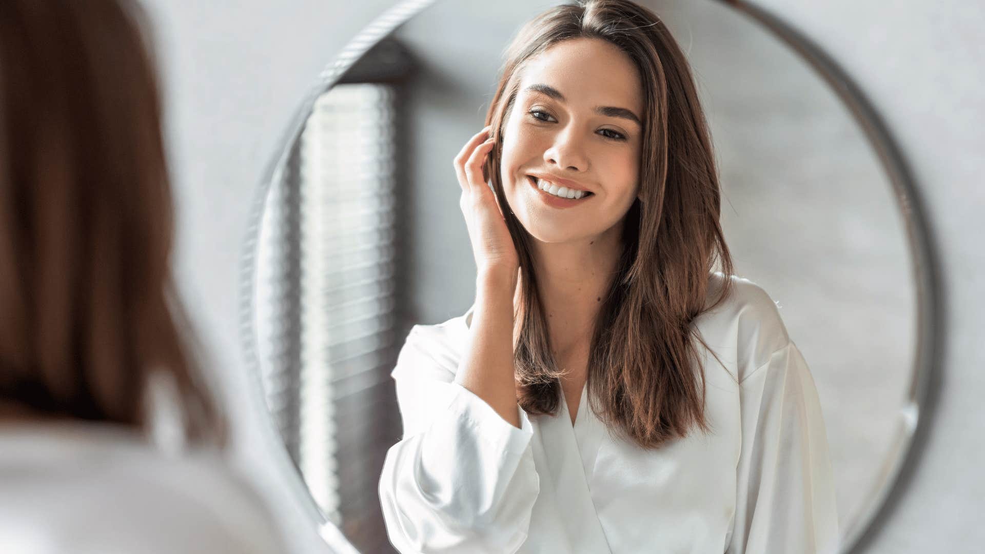 woman smiling in mirror