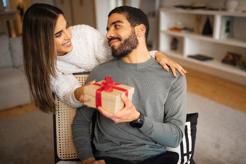 woman giving man gift