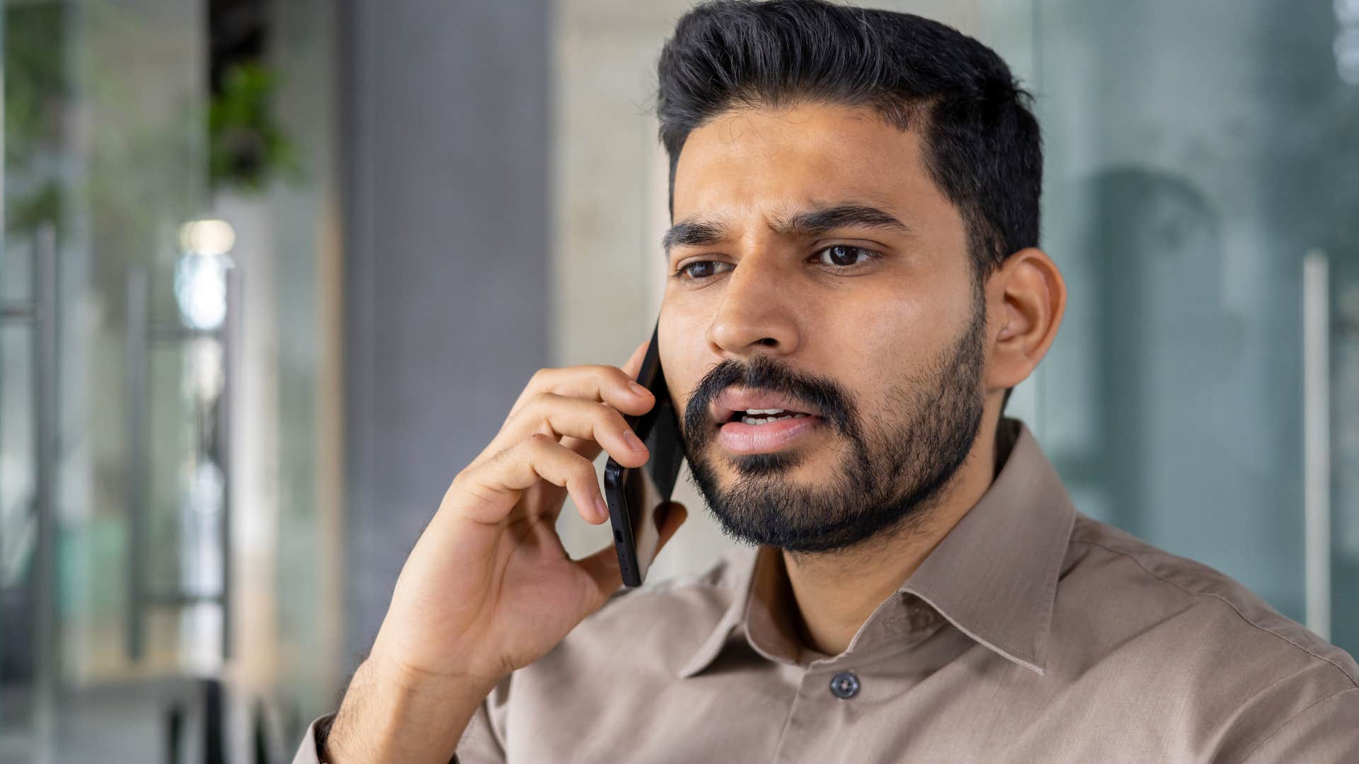 angry man arguing with someone on the phone