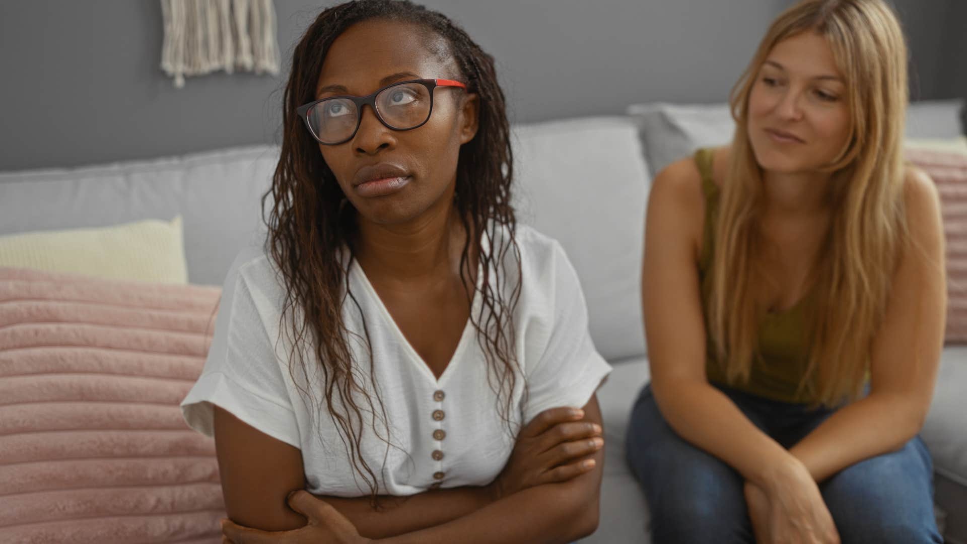 woman avoiding making eye contact with friend