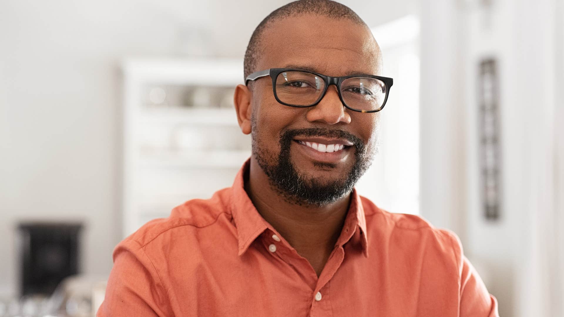 man smiling with glasses on