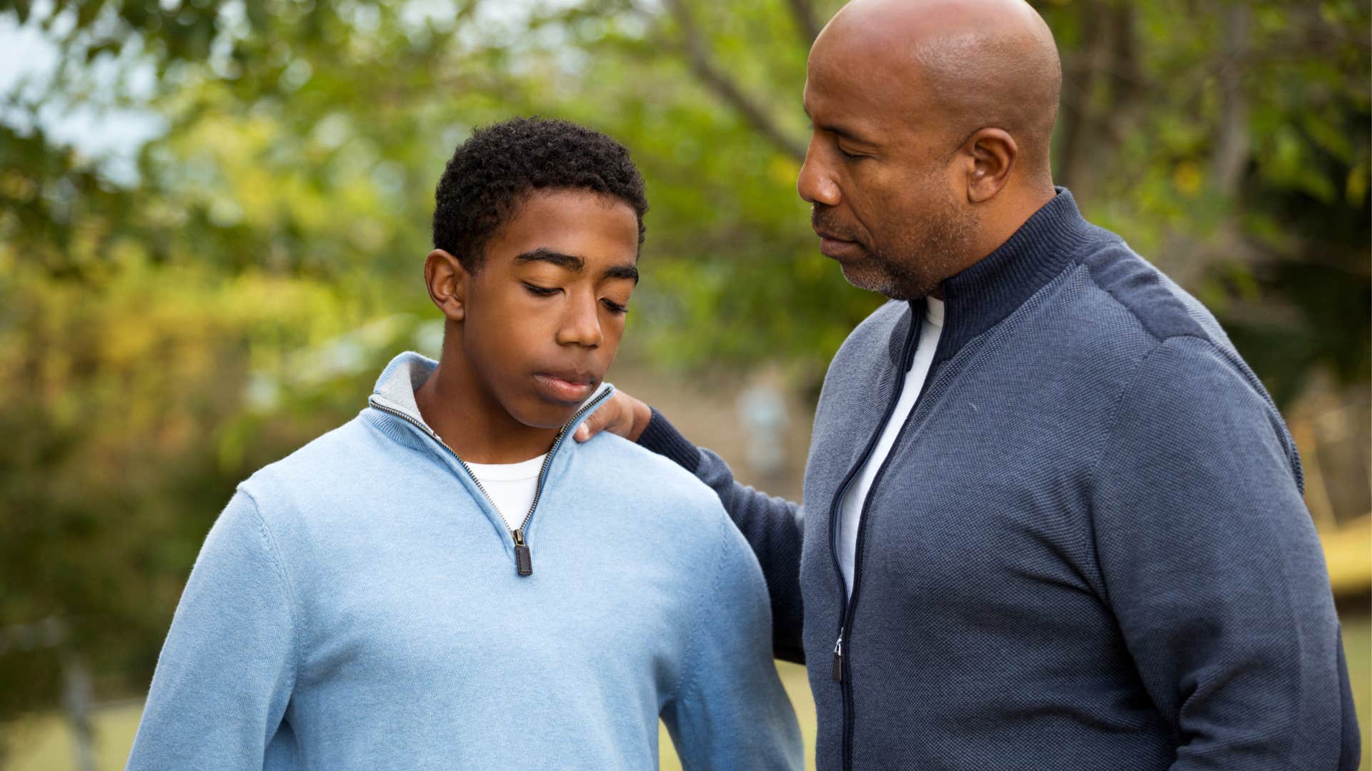 young man looking sad from fathers treatment of him