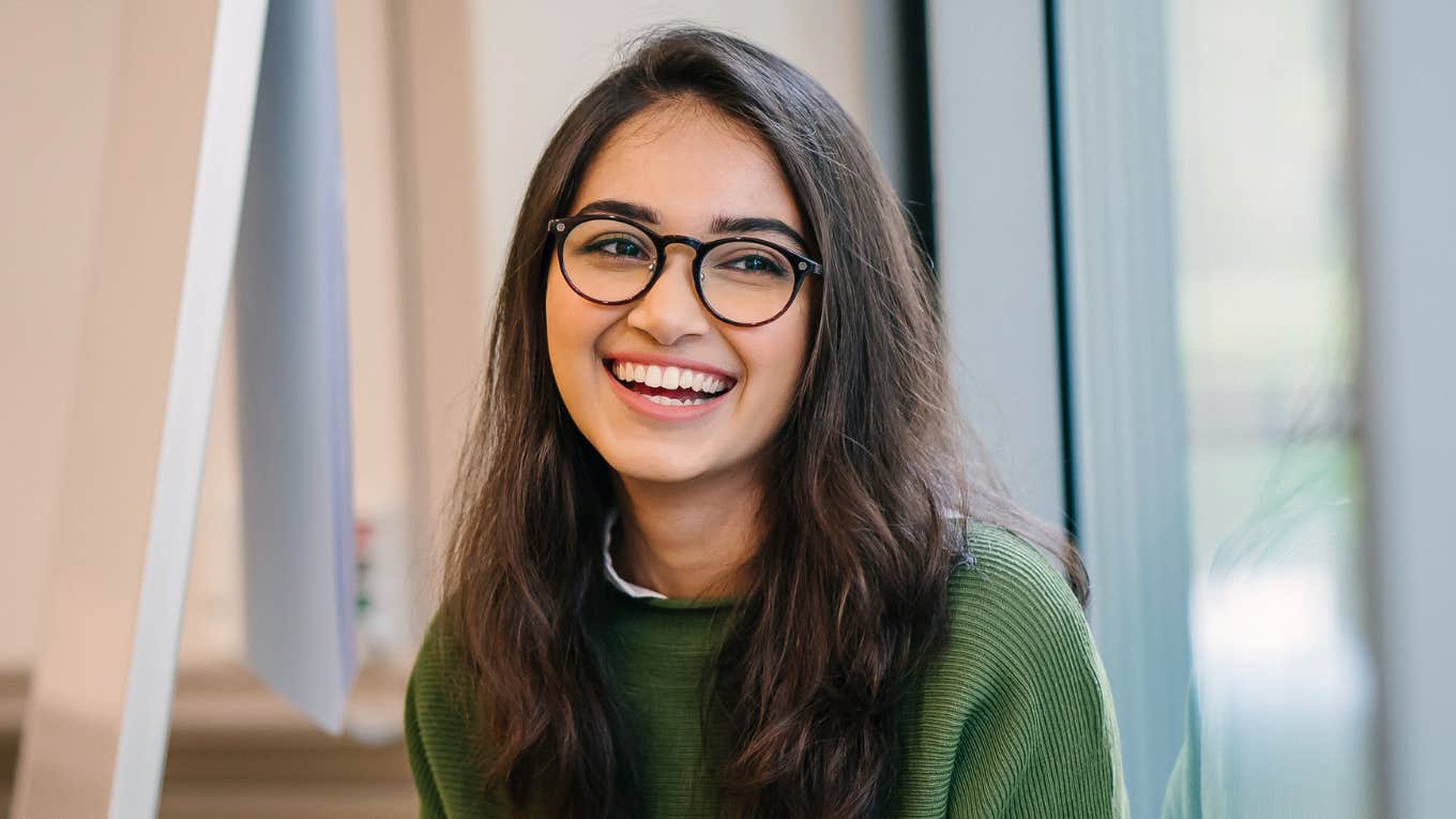 smiling young woman wearing fashionable clothes