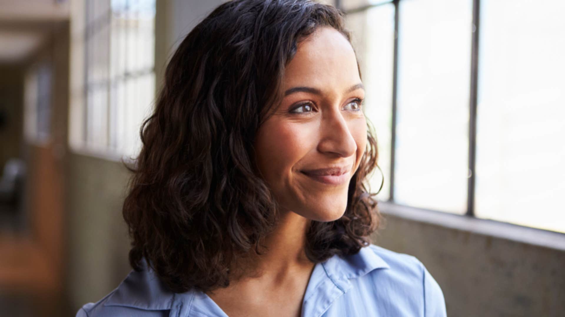 smiling woman trusting the manifestation process 