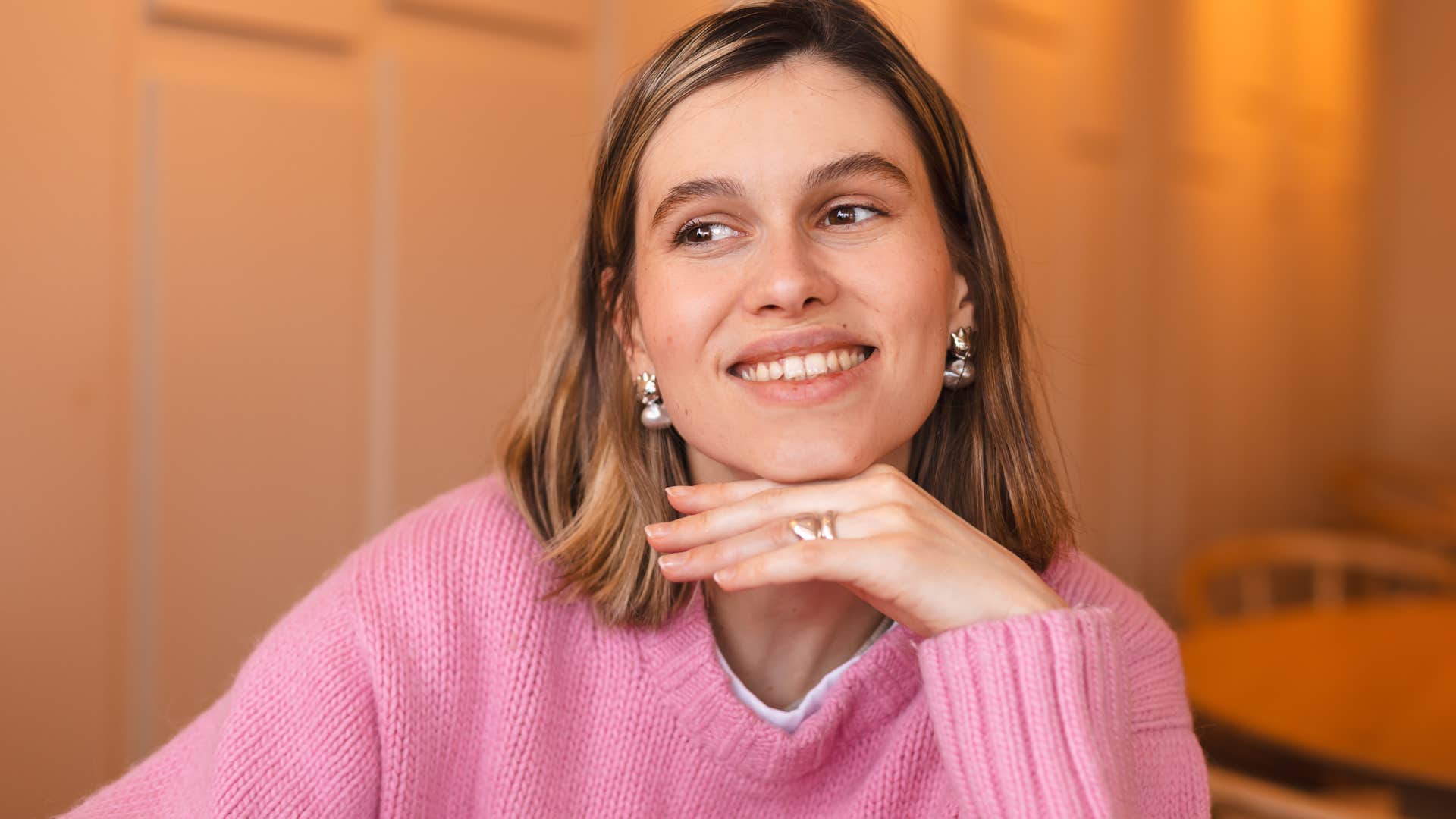 happy woman smiling wearing jewelry