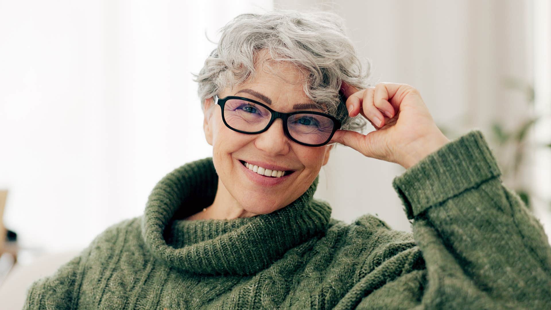 older woman wearing glasses smiling