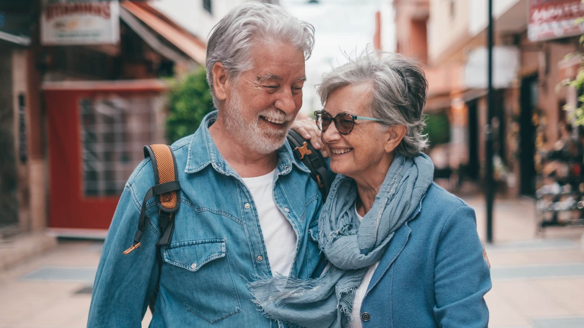 smiling senior couple walking outside