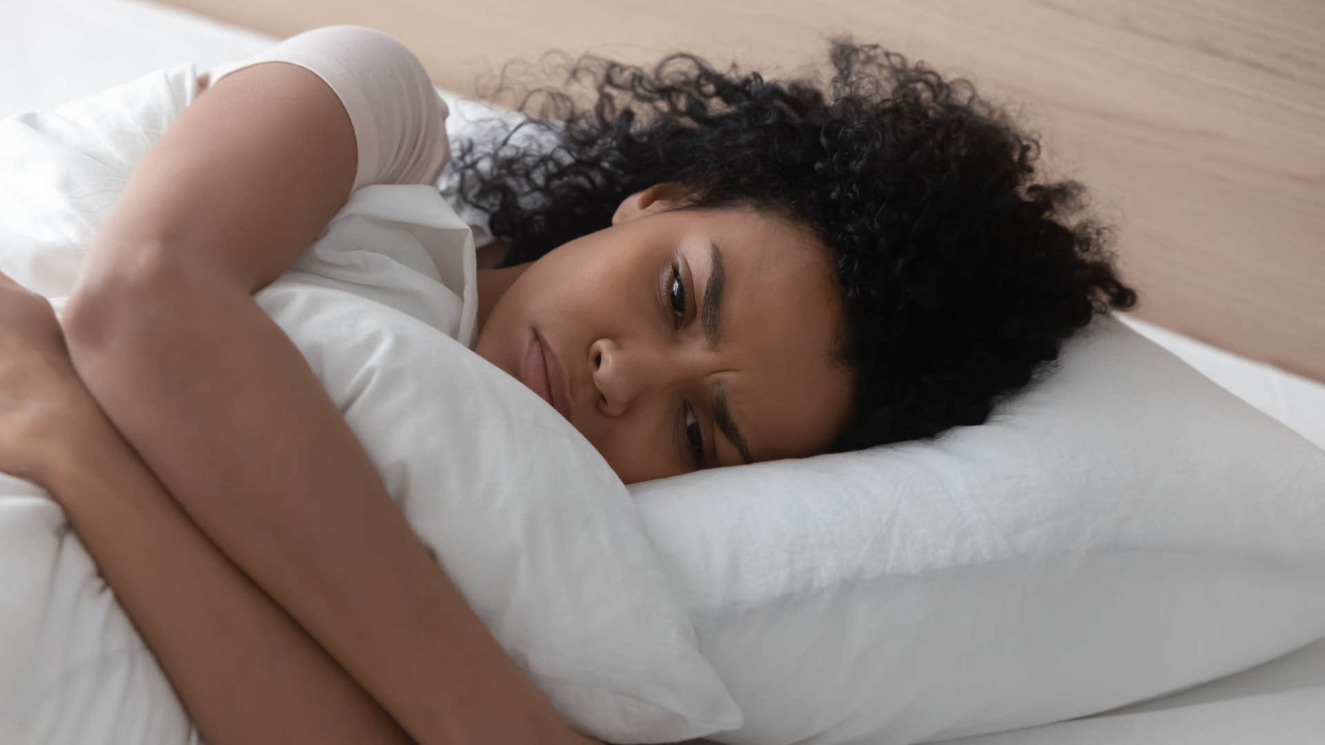 Woman laying awake in her bed.