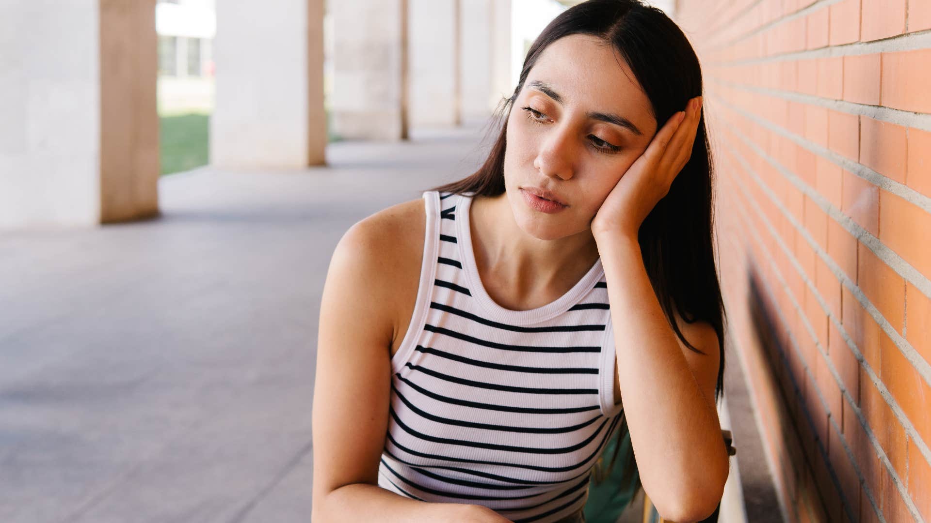 Sad woman holding her head in her hands.