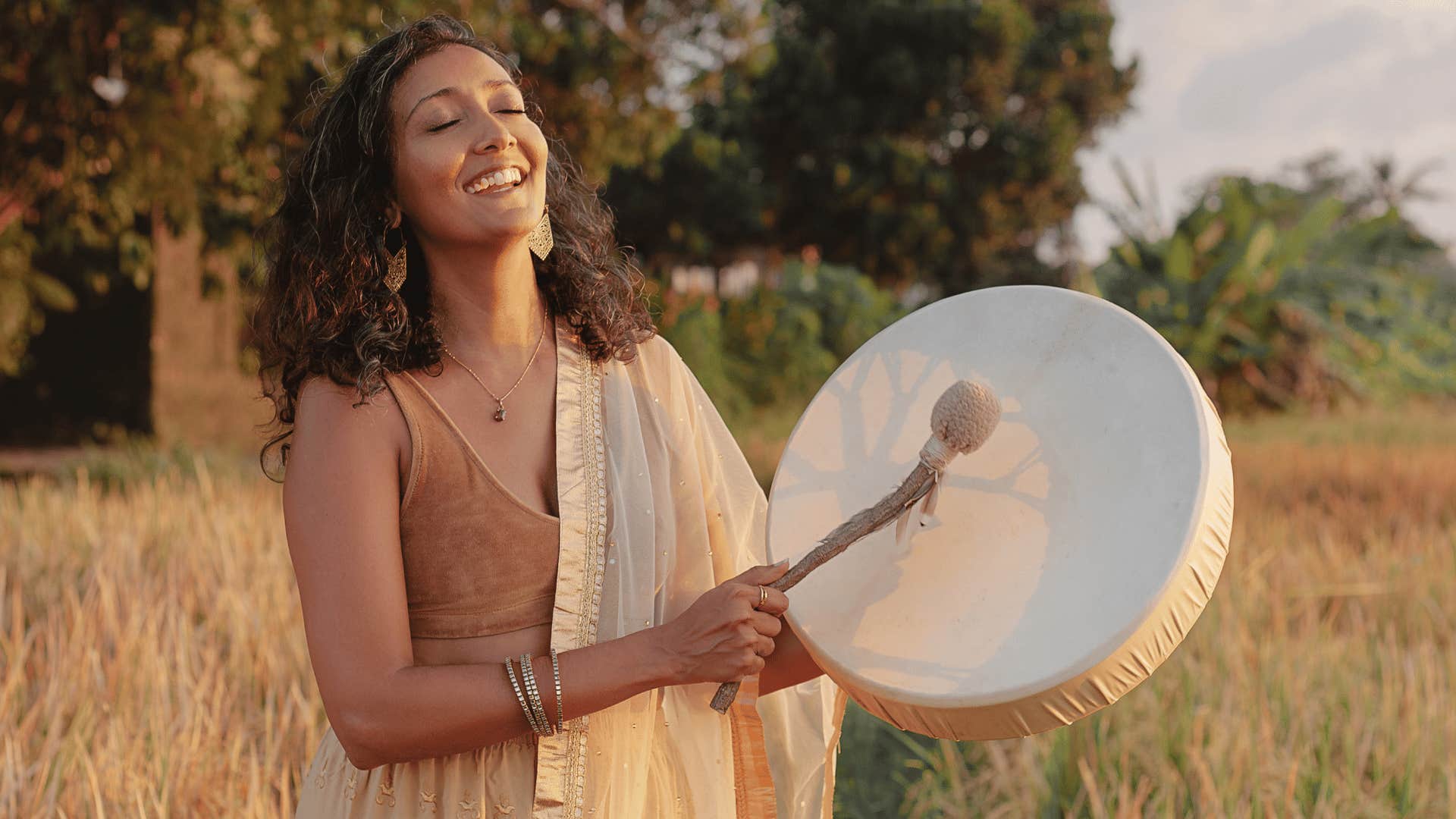 woman with drum in field