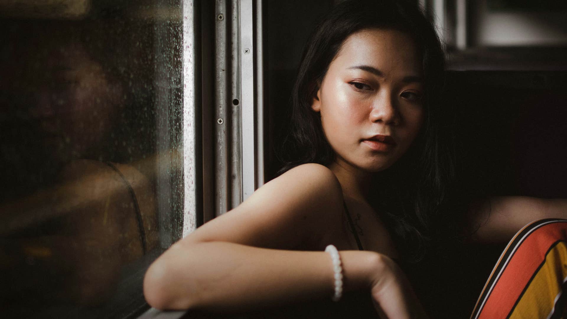 woman sitting near a bus window