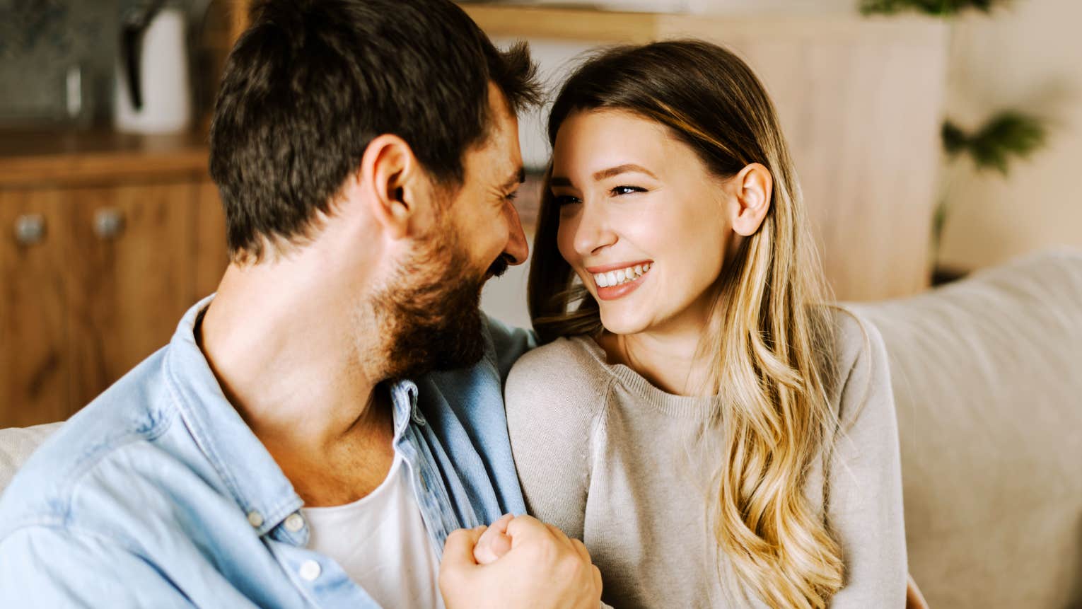 Couple communicating with each other on couch. 