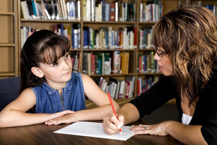 child getting tutored in library