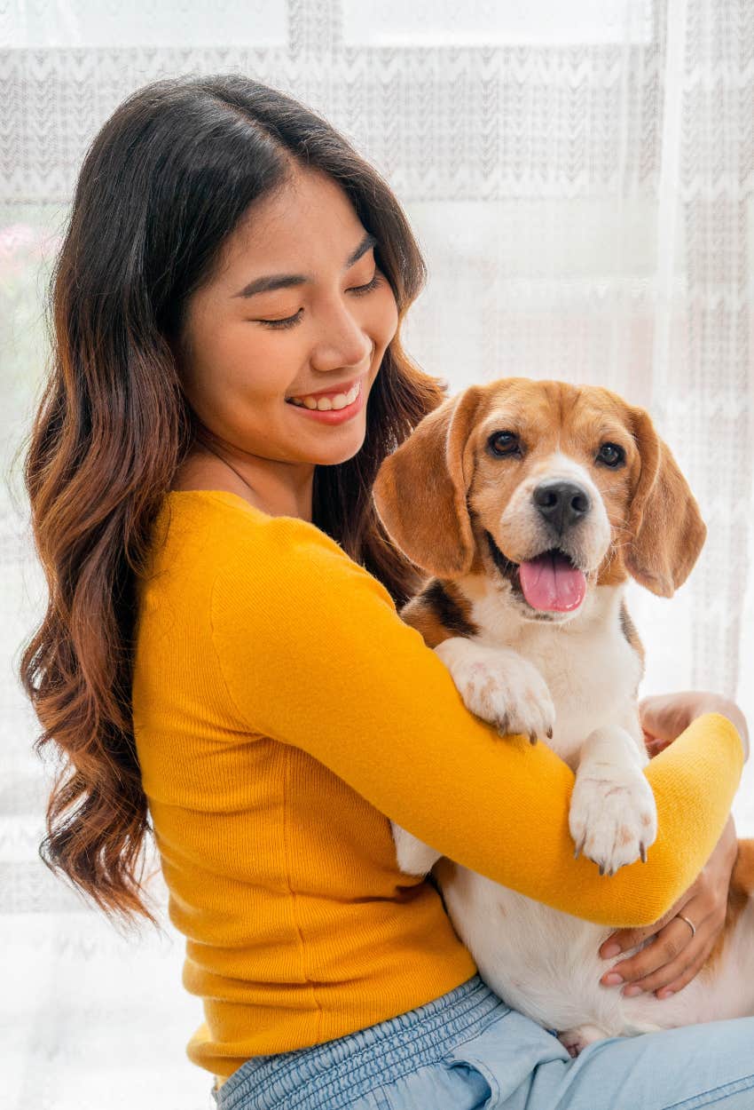 Woman holding a beagle fingernails predicting how long live