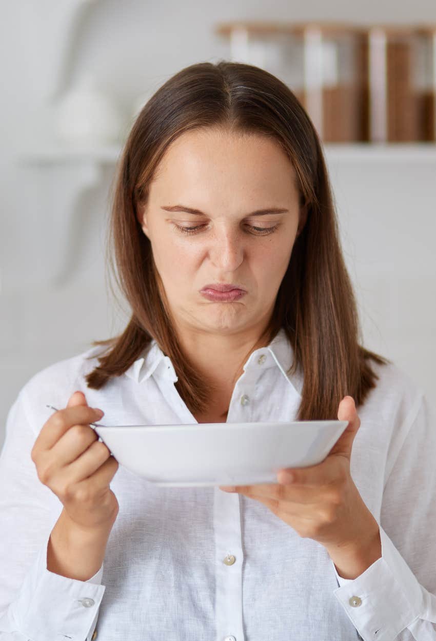 Woman retching at her husband's cooking