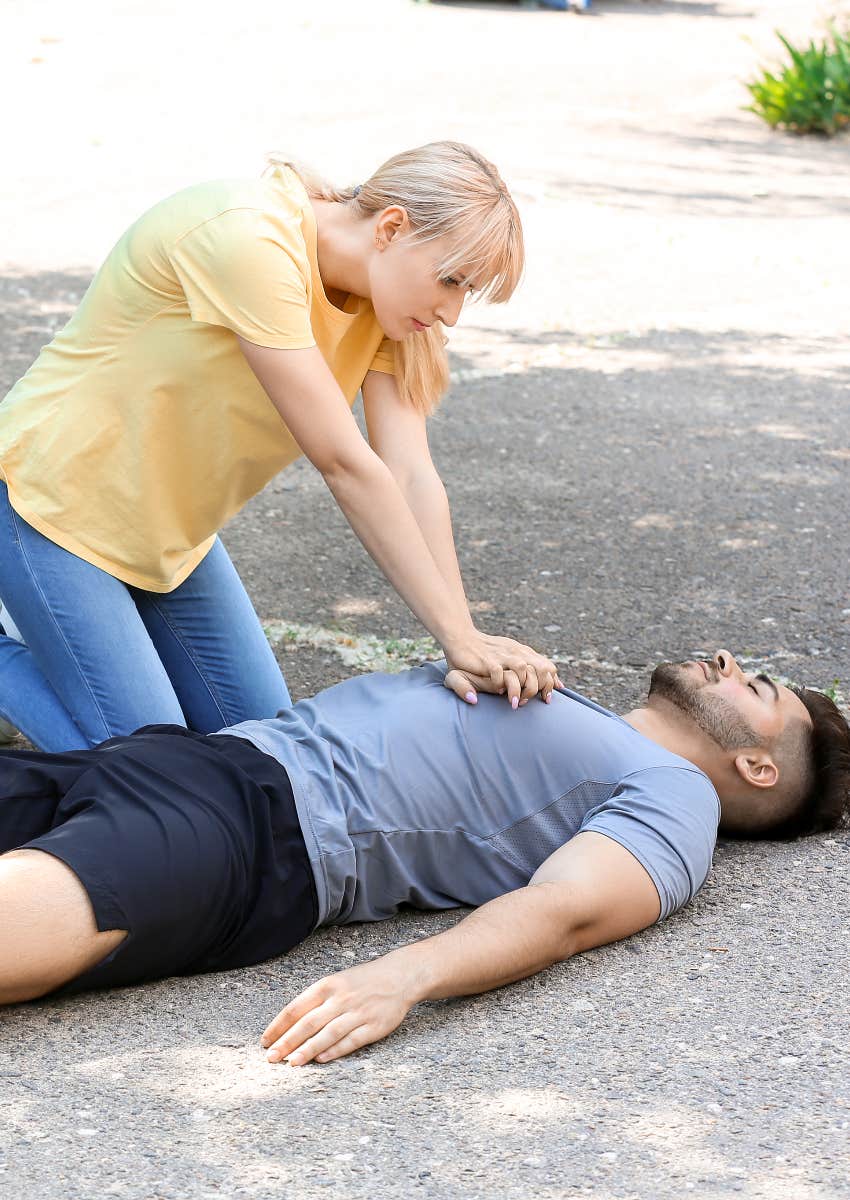 Woman giving a man CPR