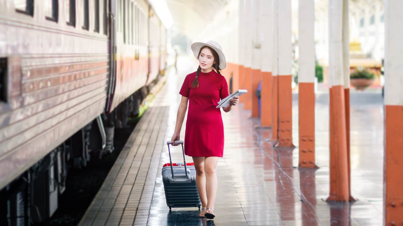 Pregnant woman about to take seat a train passenger specifically paid for