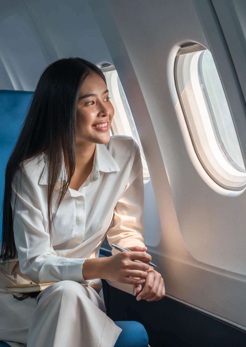 plane passenger enjoying first-class window seat