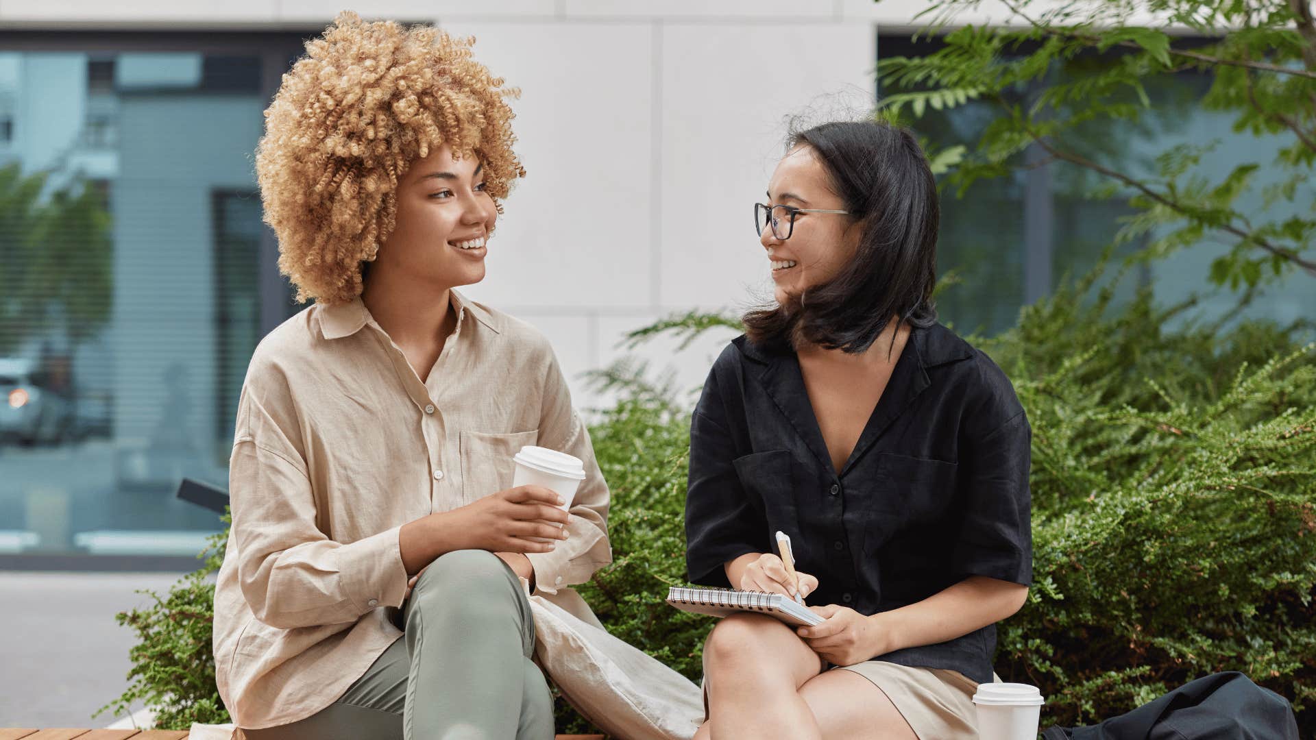 women talking while sitting outside