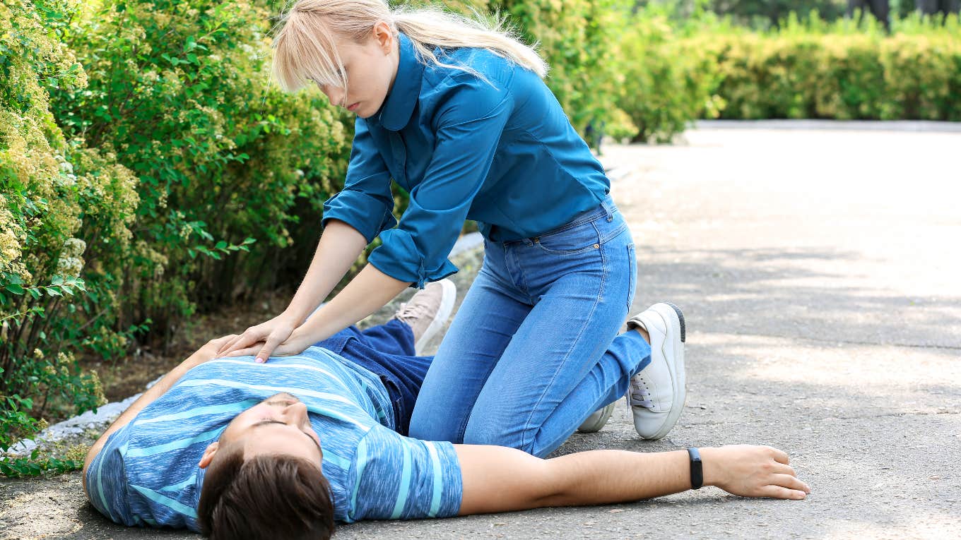 Woman giving a man CPR