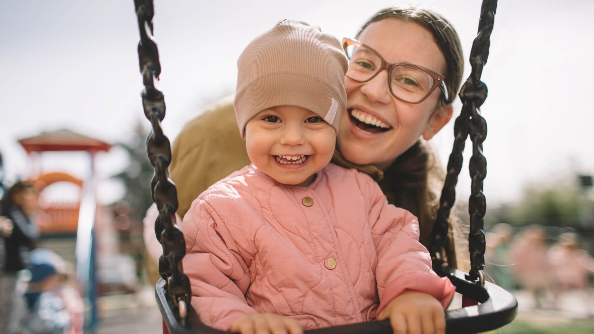 Smiling mother tells daughter eat all your vegetables to grow big and strong