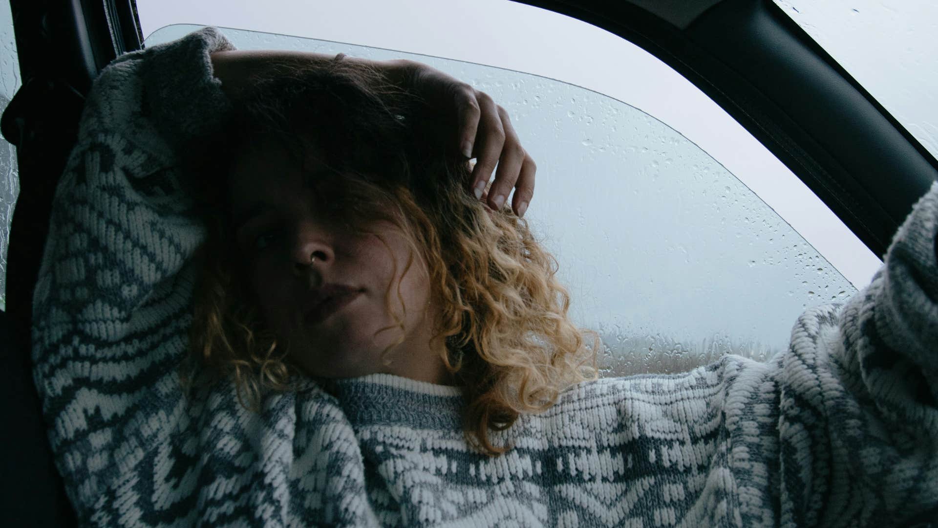 tired woman sitting in car near the window