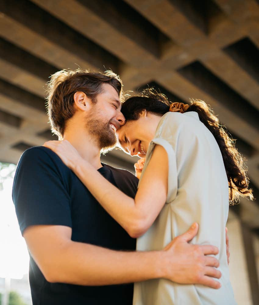 couple laughing under a bridge who get each other's humor 