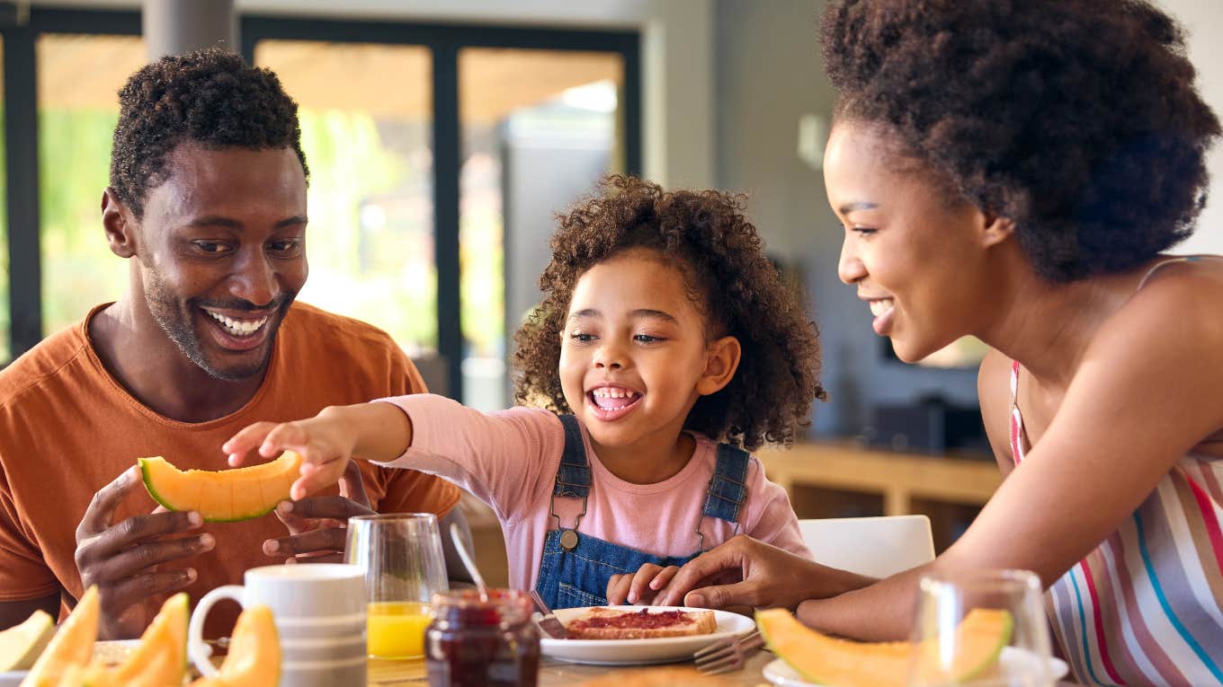 Happy family eating breakfast together at home