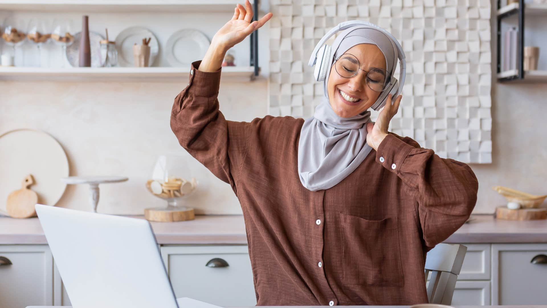 Woman smiling and dancing around the house