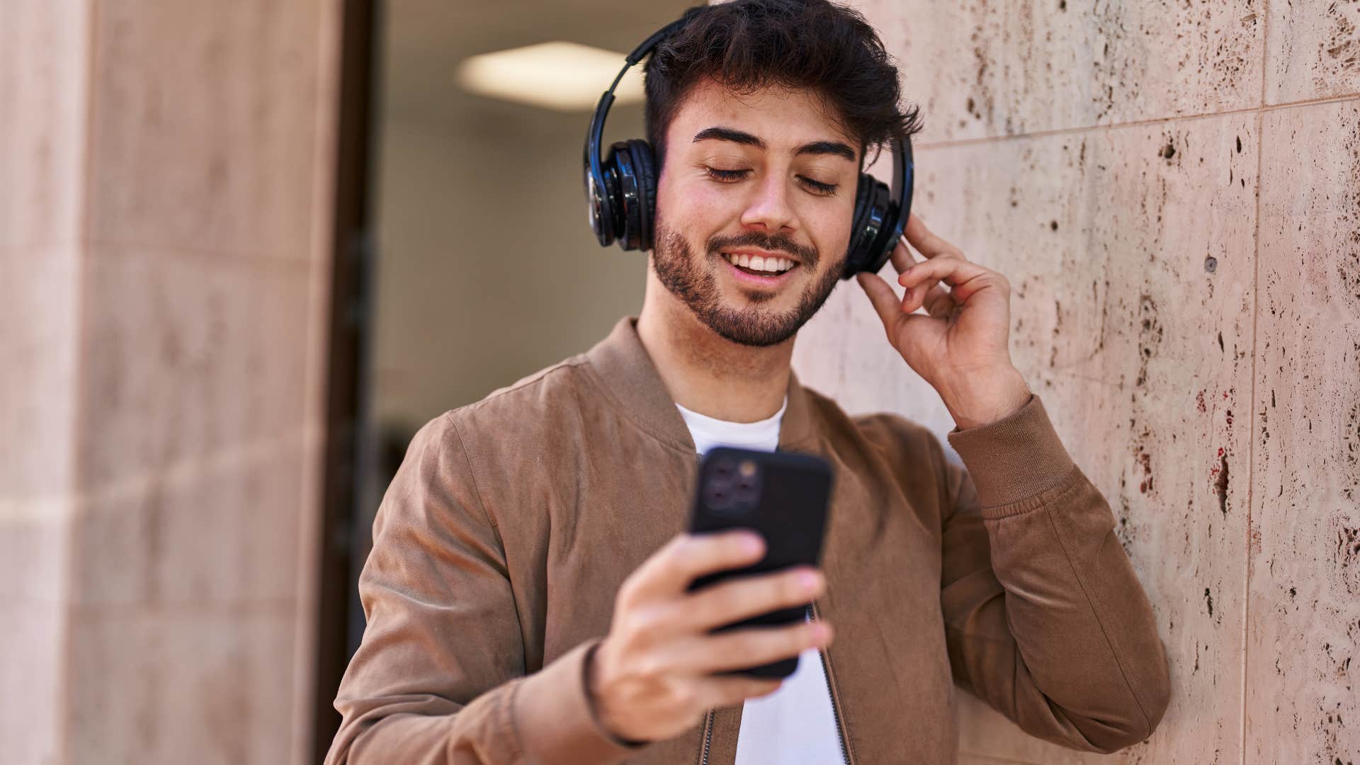 Man smiling and listening to classical music with headphones on