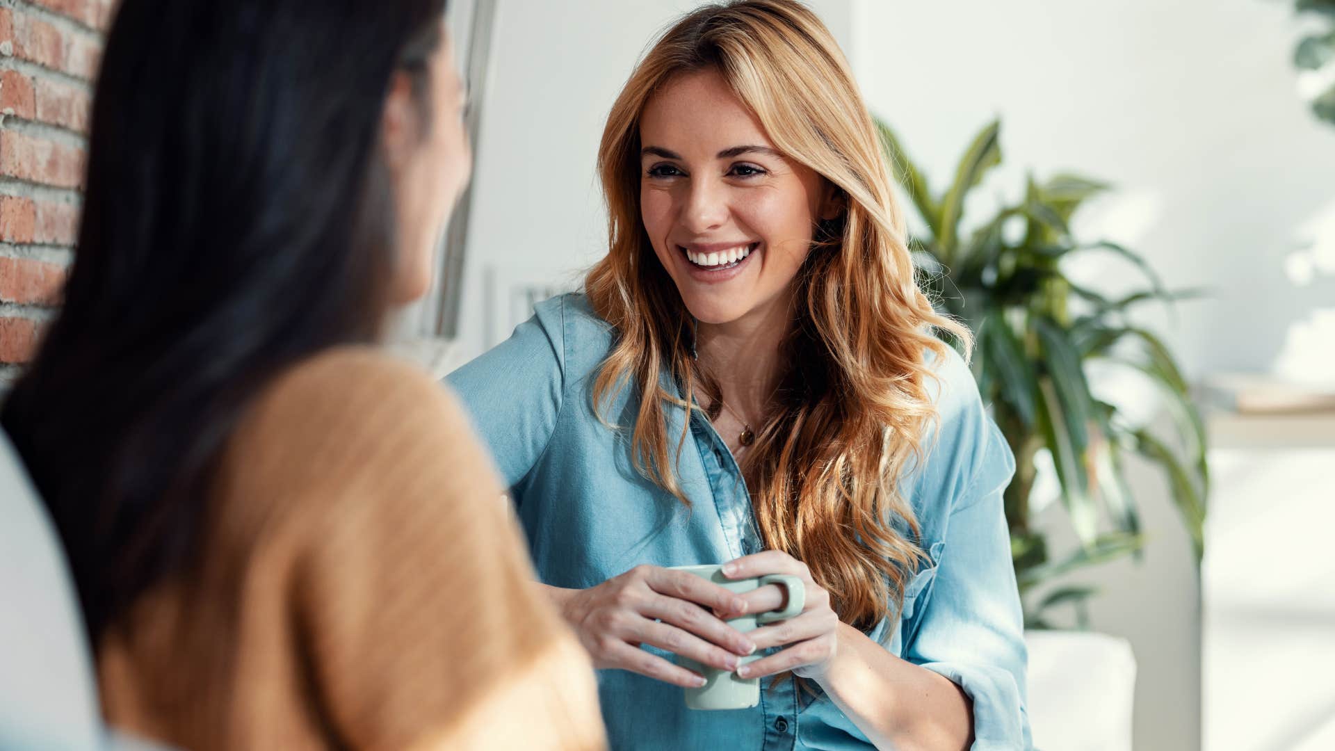 Woman smiling and connecting with a stranger in a coffee shop