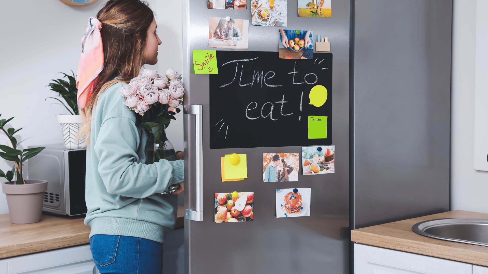 woman with fresh flowers in her kitchen