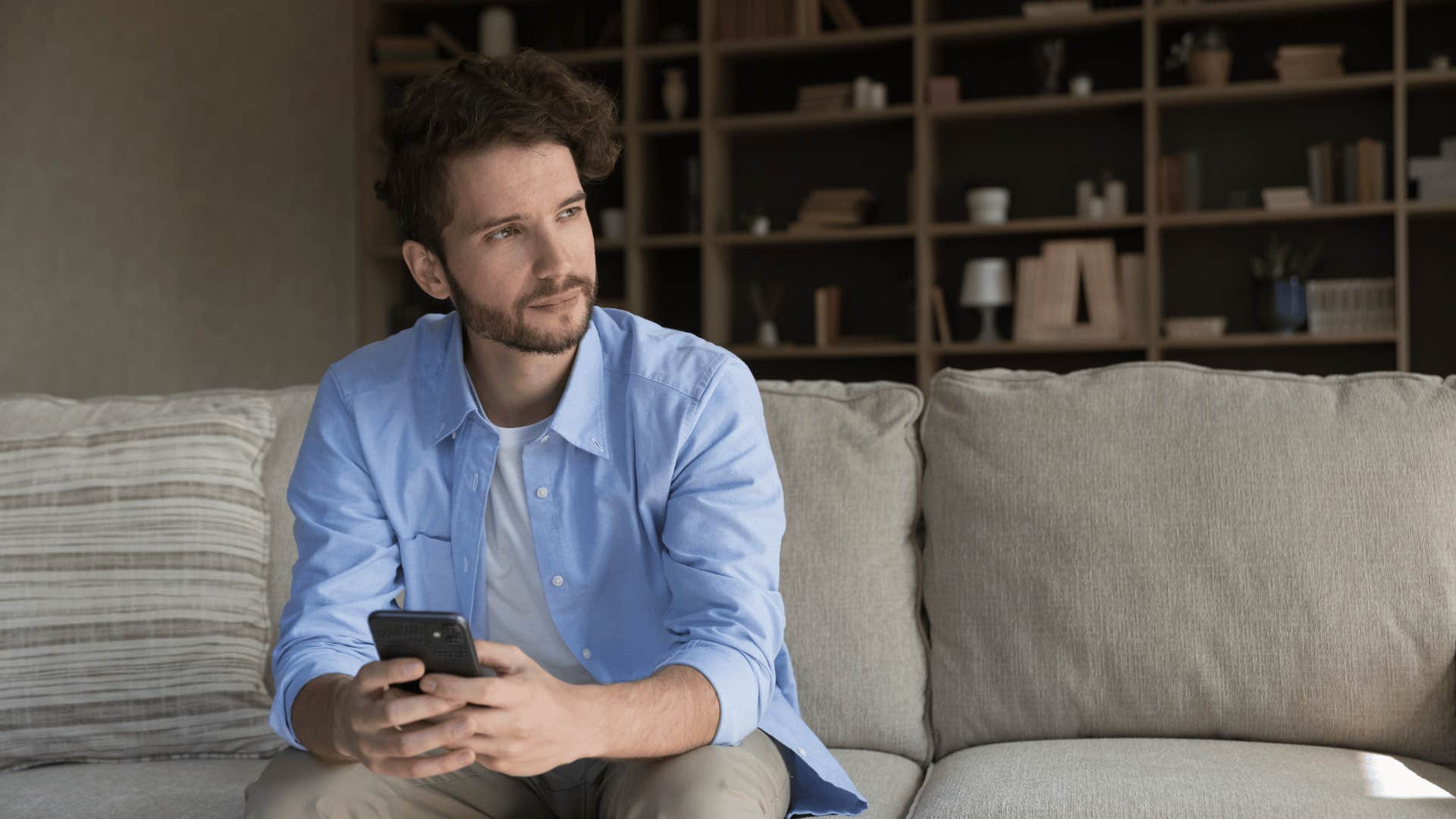 Jealous man checks his mobile phone