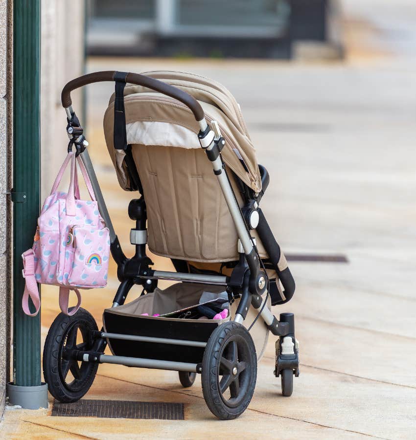 A baby stroller parked alone on the street